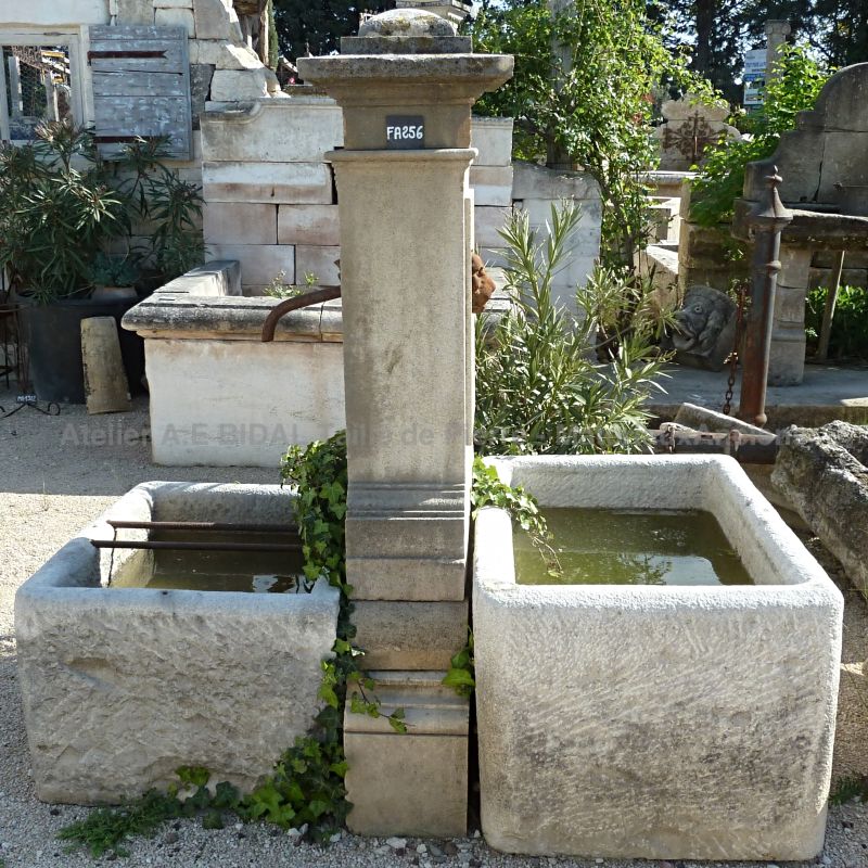 Provence fountain with 2 antique stone troughs and a central pediment for sale at Alain BIDAL Antique Materials.