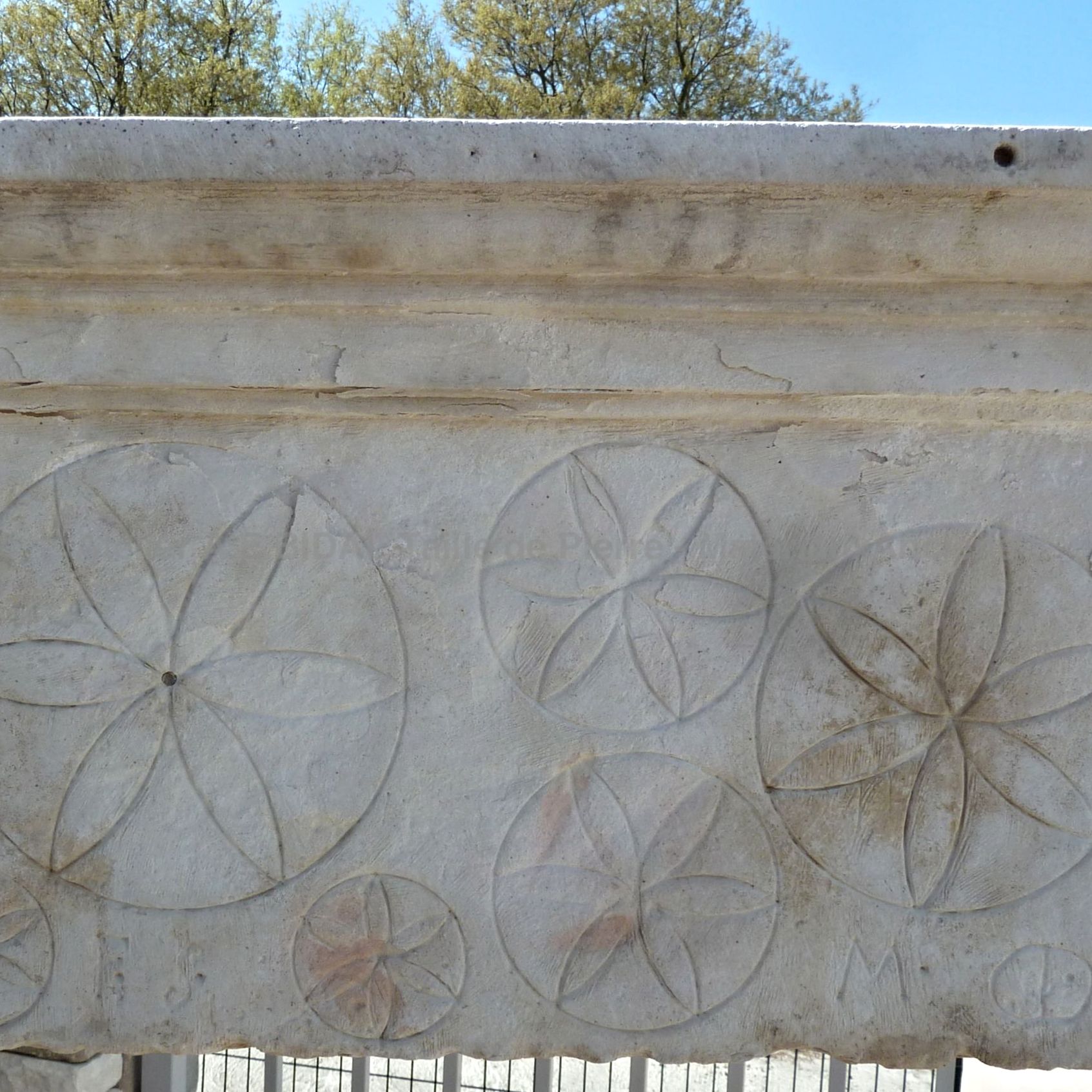 Rosettes  on a Louis 14 fireplace  signed with the name of the craftman who made it.